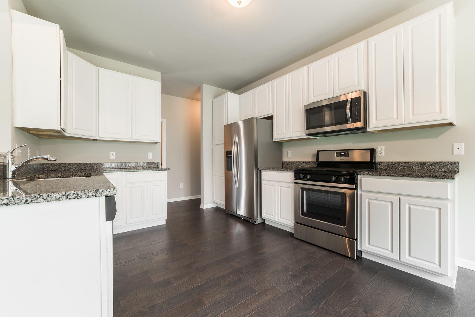 1111 Bailey Road Sycamore, IL 60178 - Photo 9 of 32 a kitchen with granite countertop a refrigerator and a stove top oven