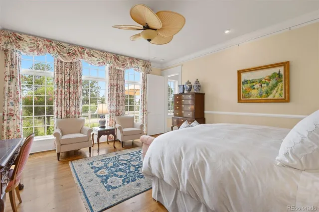 a bedroom with a bed a couch and a large window