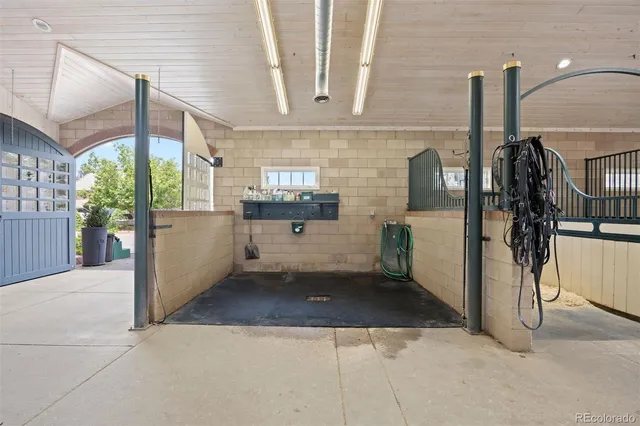 a kitchen with stainless steel appliances kitchen island granite countertop a refrigerator and a sink