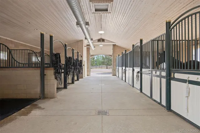 a hallway with a large window and refrigerator