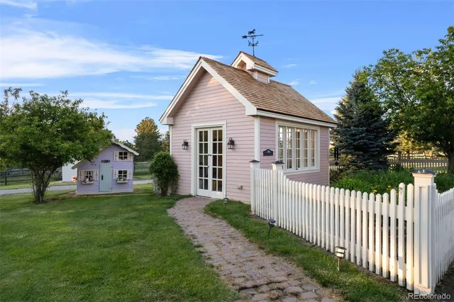 a bathroom with a double vanity sink a mirror and a bathtub