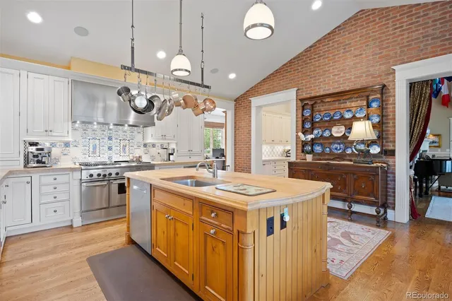 a kitchen with stainless steel appliances granite countertop a stove and a large kitchen island