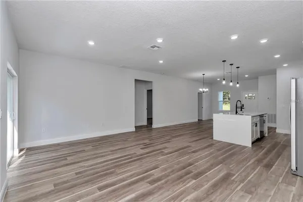 a view of kitchen and kitchen with a wooden floor