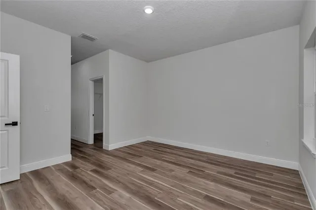 a view of room with wooden floor