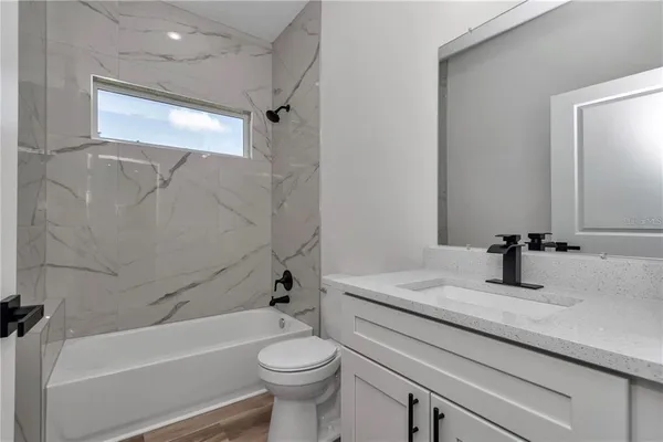 a bathroom with a sink a toilet and a bathtub