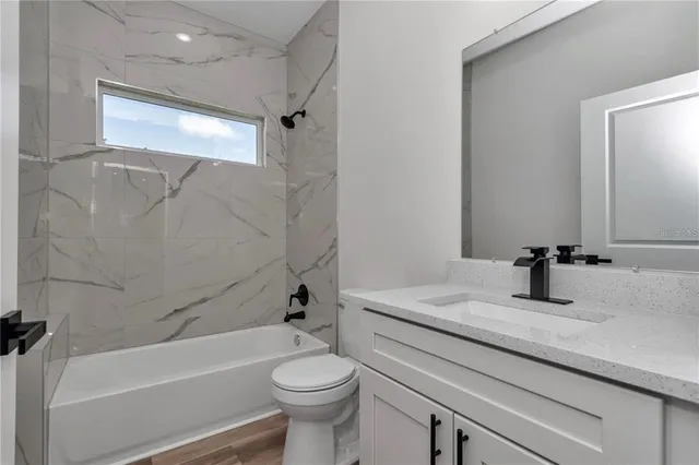 a bathroom with a sink a toilet and a bathtub