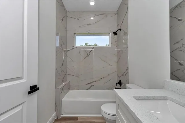 a bathroom with a toilet sink and bathtub