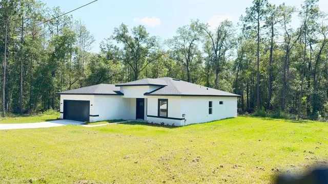 a white house that has a large pool in front of it