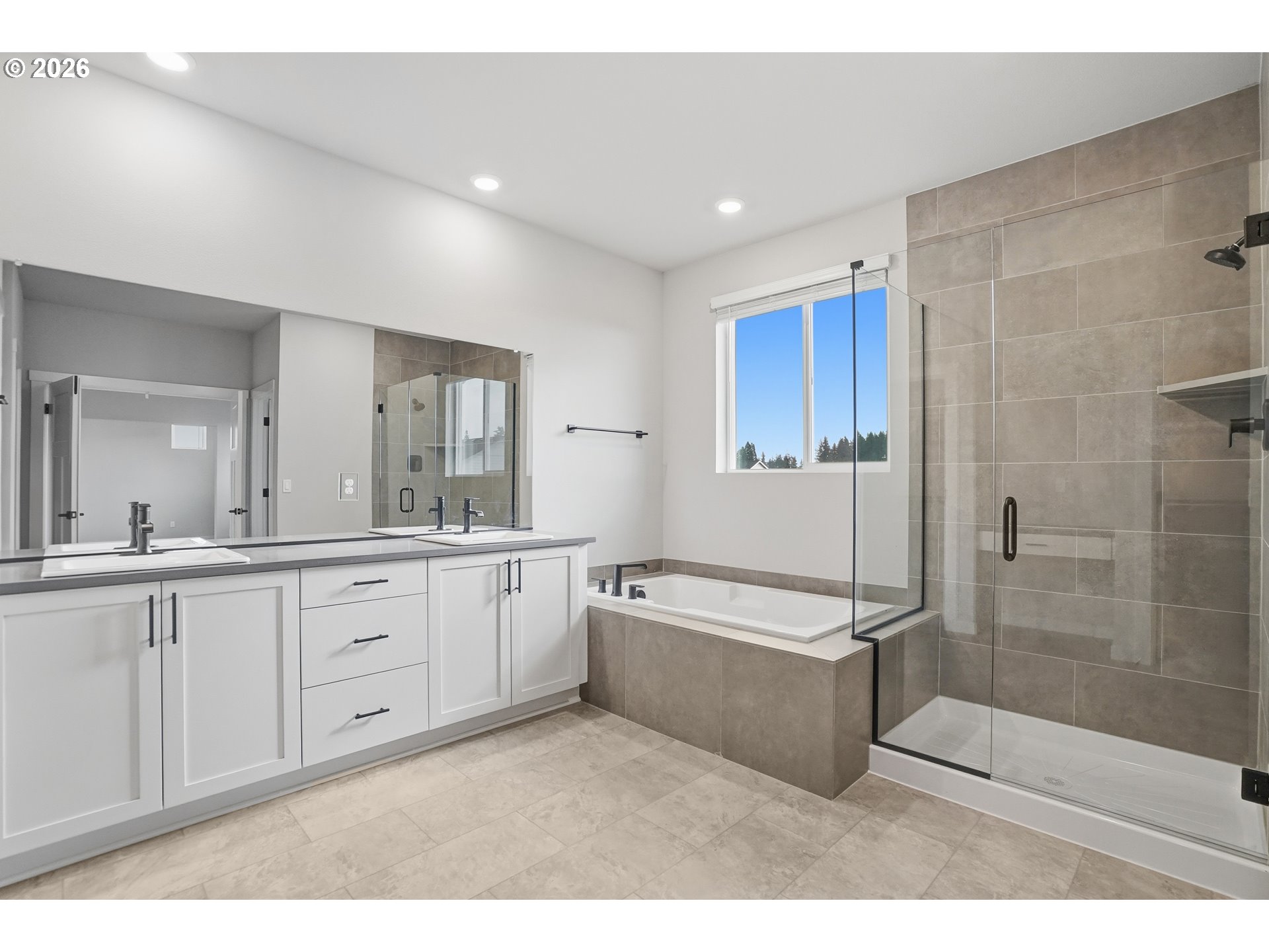 5514 North 88th Avenue Camas, WA 98607 - Photo 12 of 17 a spacious bathroom with a double vanity sink a mirror and a bathtub