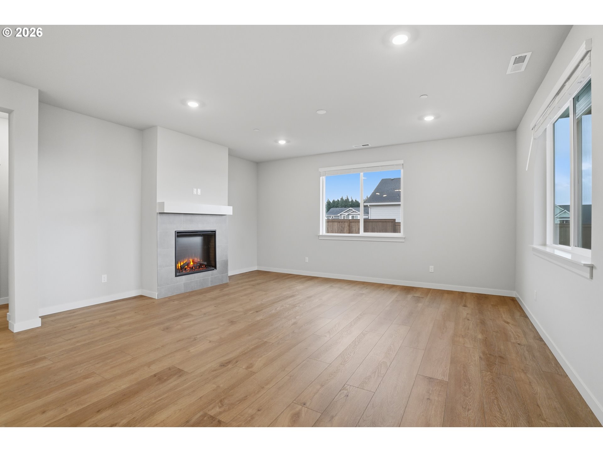 5514 North 88th Avenue Camas, WA 98607 - Photo 5 of 17 a view of empty room with wooden floor and fireplace