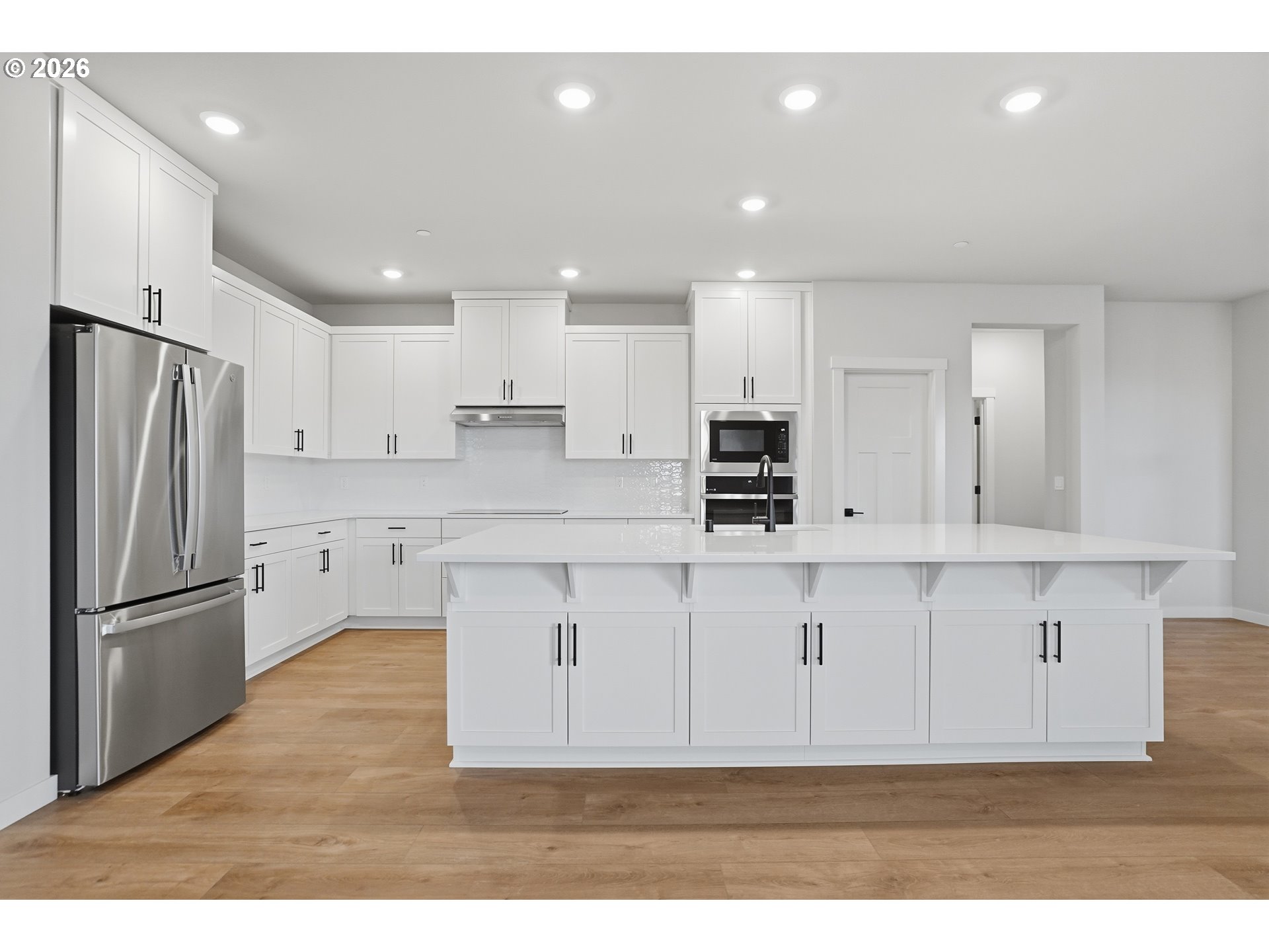 5514 North 88th Avenue Camas, WA 98607 - Photo 6 of 17 a kitchen with stainless steel appliances granite countertop a refrigerator sink and white cabinets