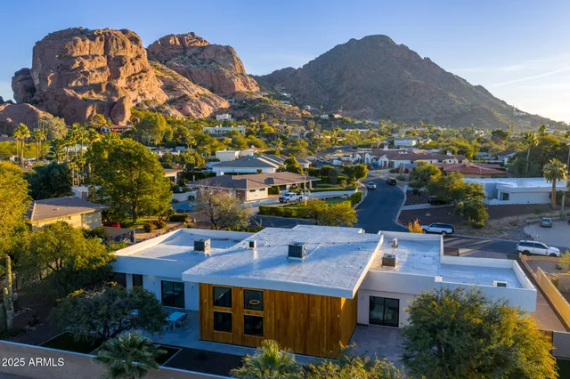 a view of a chairs and table in the backyard