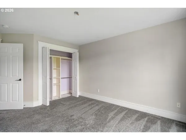 a view of an empty room and wooden floor