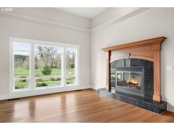 a living room with a fireplace and a floor to ceiling window