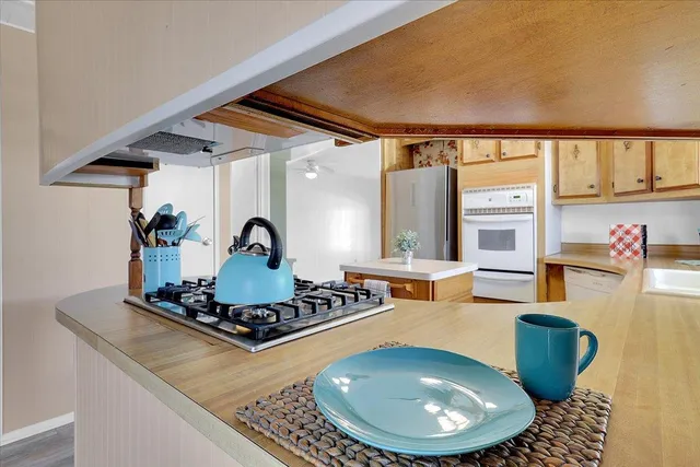 a kitchen with a stove and a wooden cabinets