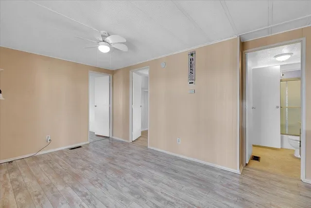 a kitchen with stainless steel appliances a refrigerator and wooden floor
