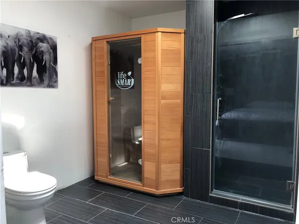 a bathroom with a toilet and a shower