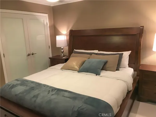 a bedroom with a bed and a night stand