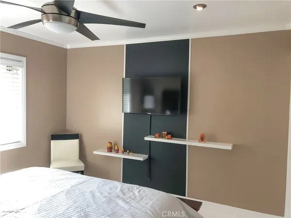 a bedroom with a bed and a mirror