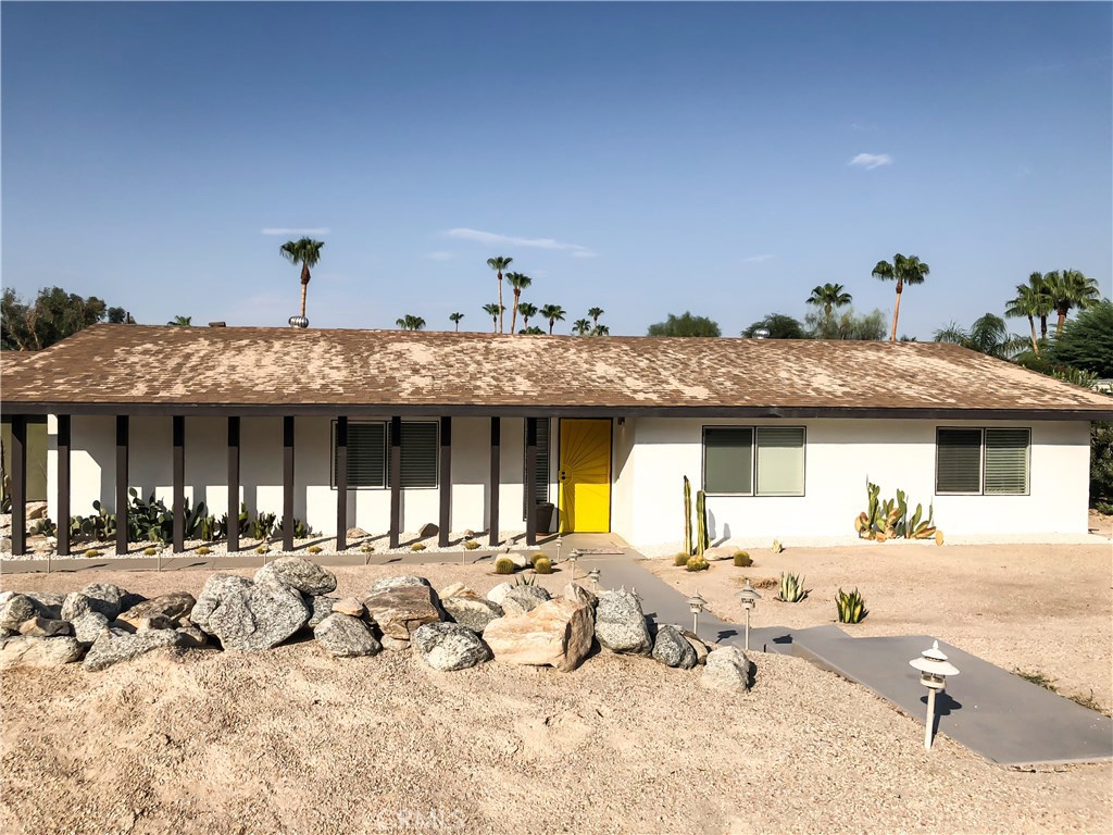 71292 Biskra Road Rancho Mirage, CA 92270 - Photo 22 of 27 a front view of a house with a yard outdoor seating and kitchen view