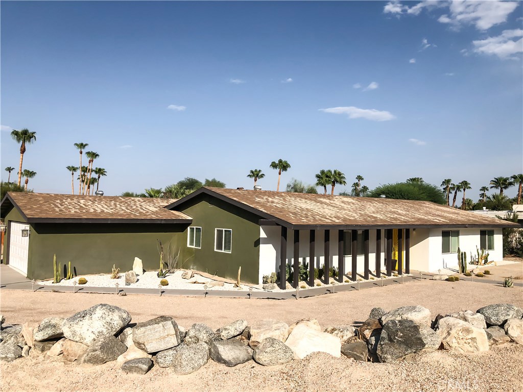 71292 Biskra Road Rancho Mirage, CA 92270 - Photo 23 of 27 a view of a house with a yard and covered in snow