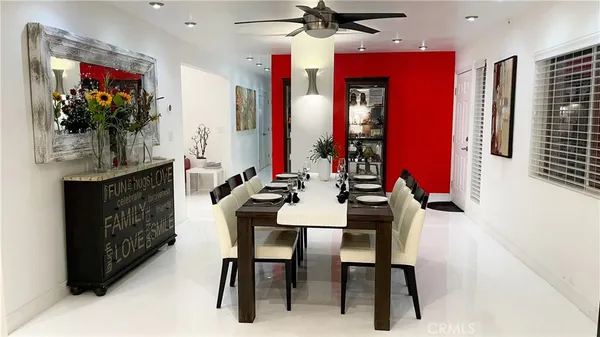 a view of a dining room with furniture and chandelier