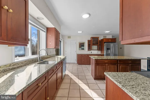 a view of empty room with wooden floor and fireplace