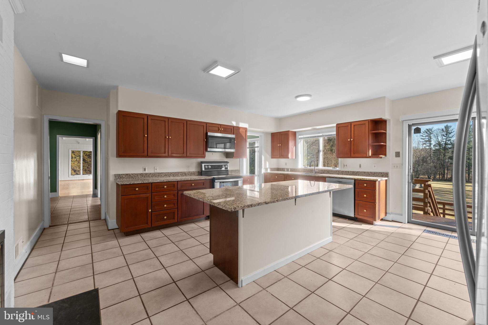 901 Walker Road Great Falls, VA 22066 - Photo 14 of 76 a large kitchen with stainless steel appliances granite countertop a stove and cabinets
