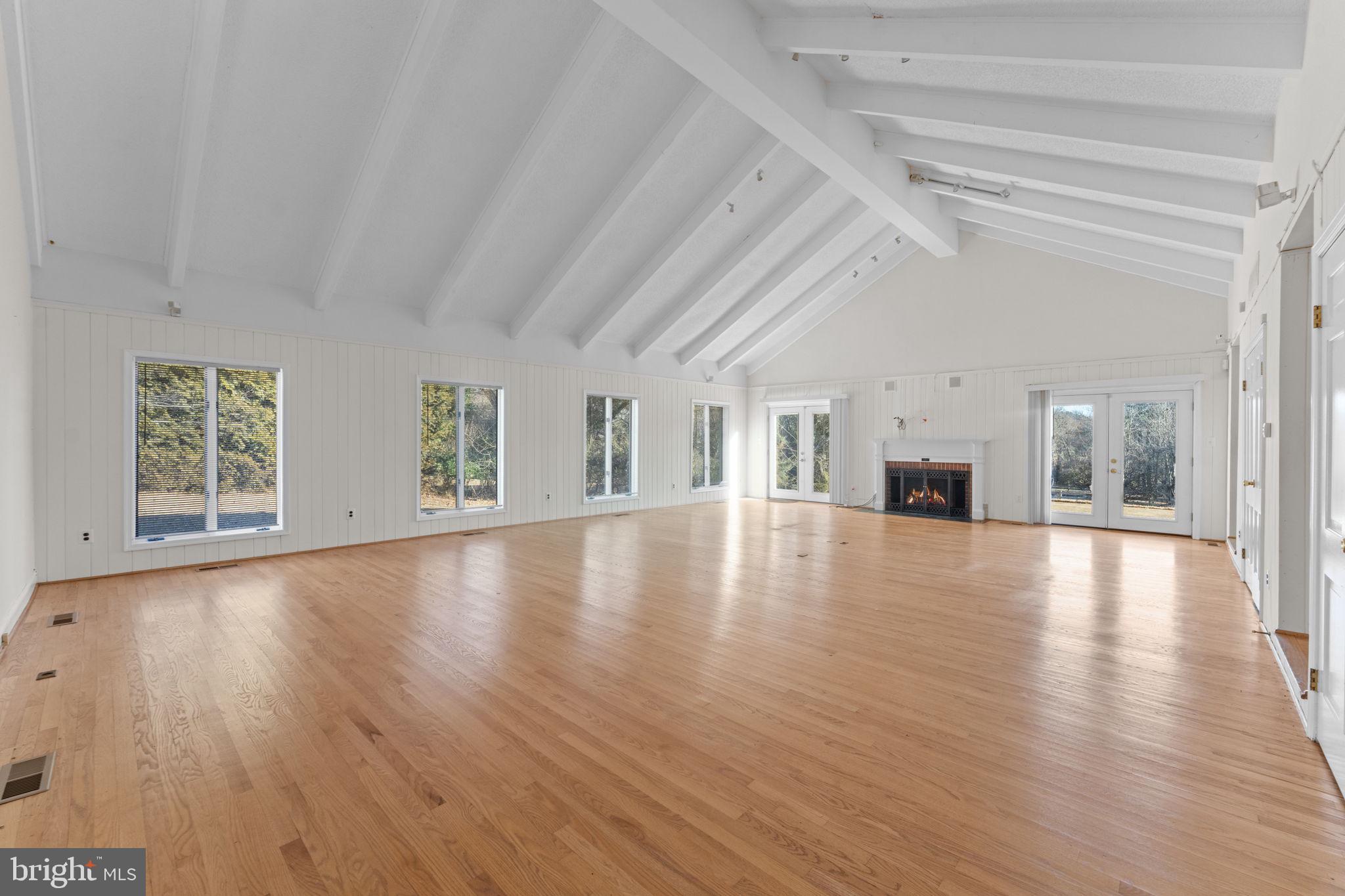 901 Walker Road Great Falls, VA 22066 - Photo 19 of 76 a view of empty room with wooden floor and fireplace