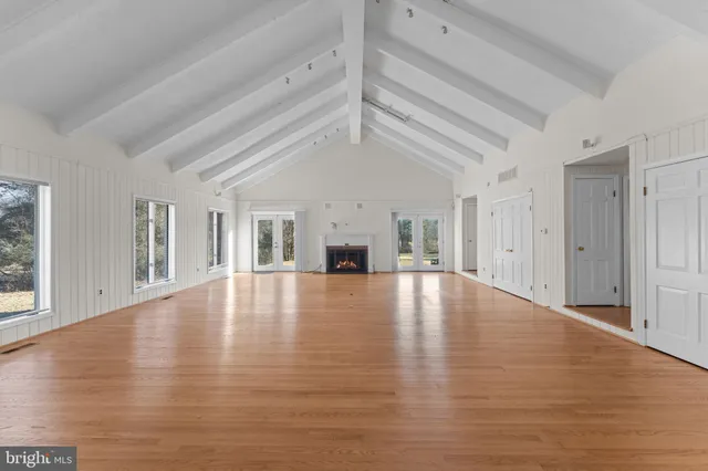a view of empty room with fireplace and window