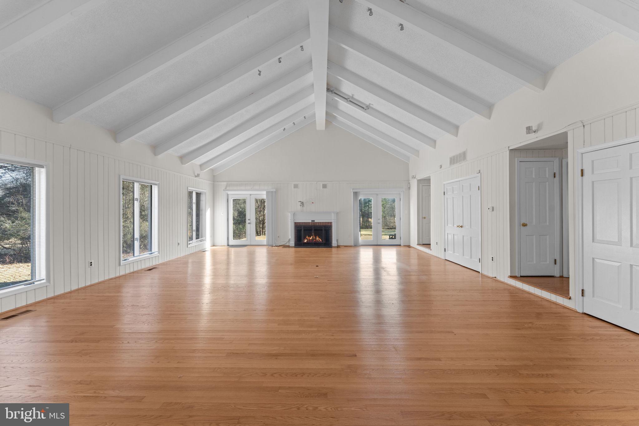 901 Walker Road Great Falls, VA 22066 - Photo 22 of 76 a view of empty room with wooden floor and fireplace