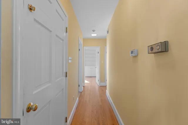 a view of an empty room with a fireplace and a window