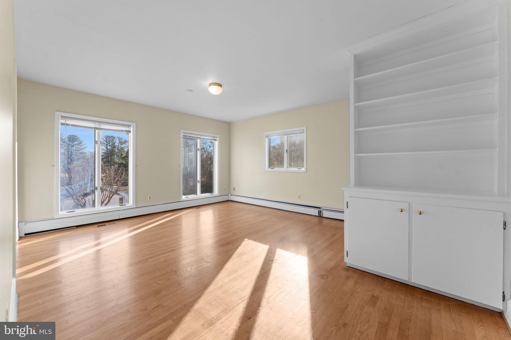 901 Walker Road Great Falls, VA 22066 - Photo 24 of 76 a view of an empty room with wooden floor and a window
