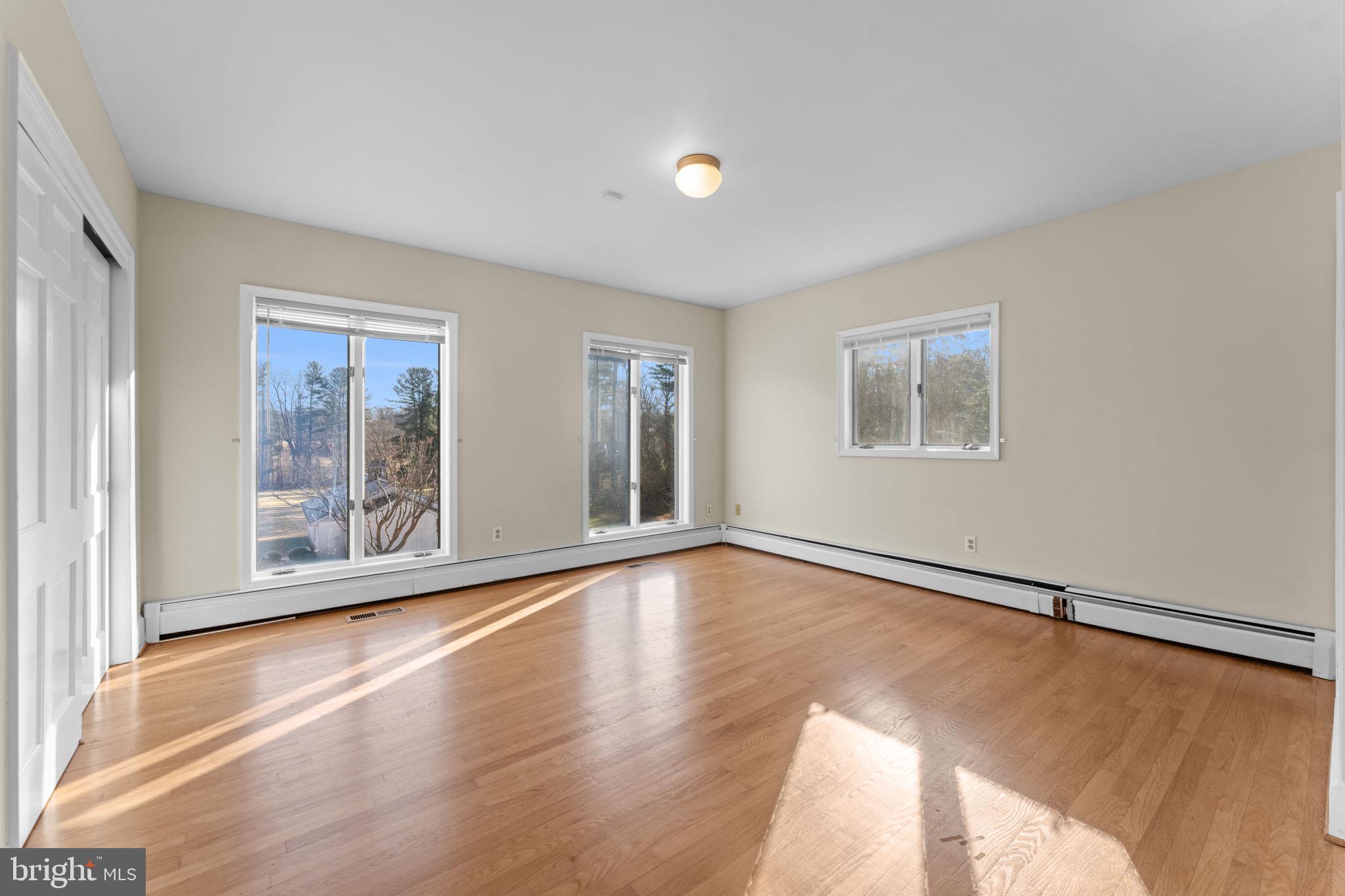 901 Walker Road Great Falls, VA 22066 - Photo 25 of 76 a view of an empty room with a window and wooden floor
