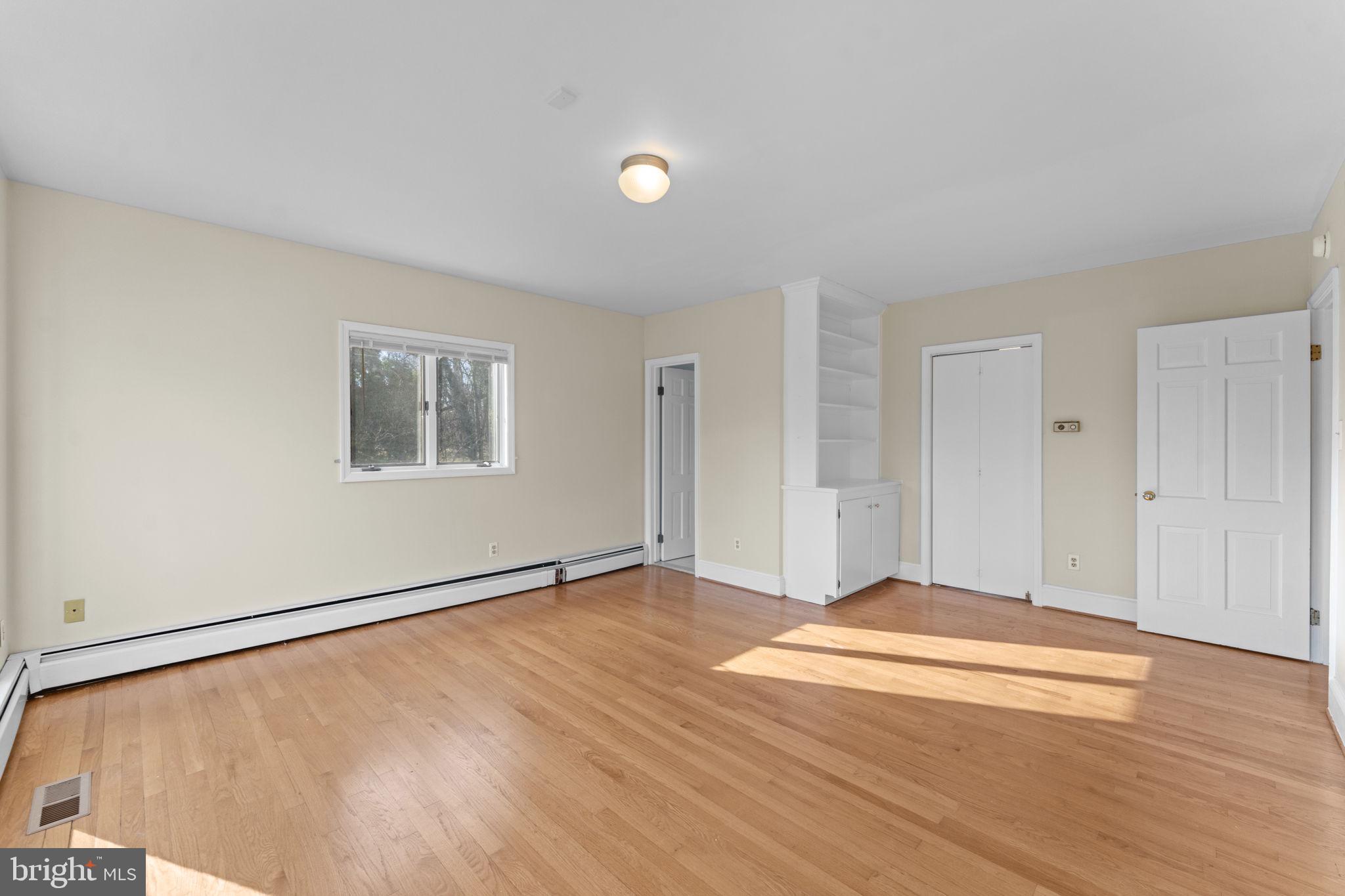 901 Walker Road Great Falls, VA 22066 - Photo 26 of 76 a view of an empty room with wooden floor and a window