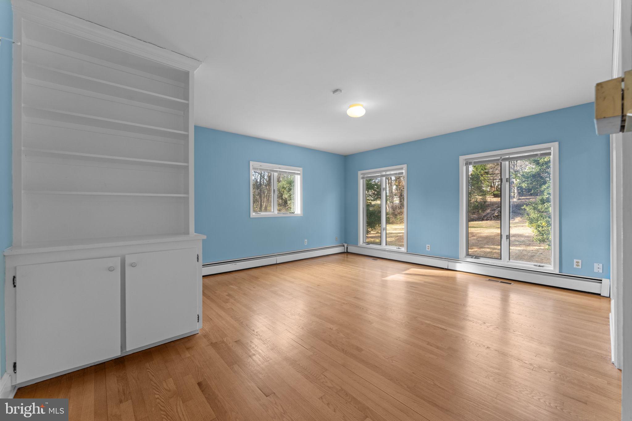 901 Walker Road Great Falls, VA 22066 - Photo 29 of 76 a view of an empty room with wooden floor and windows