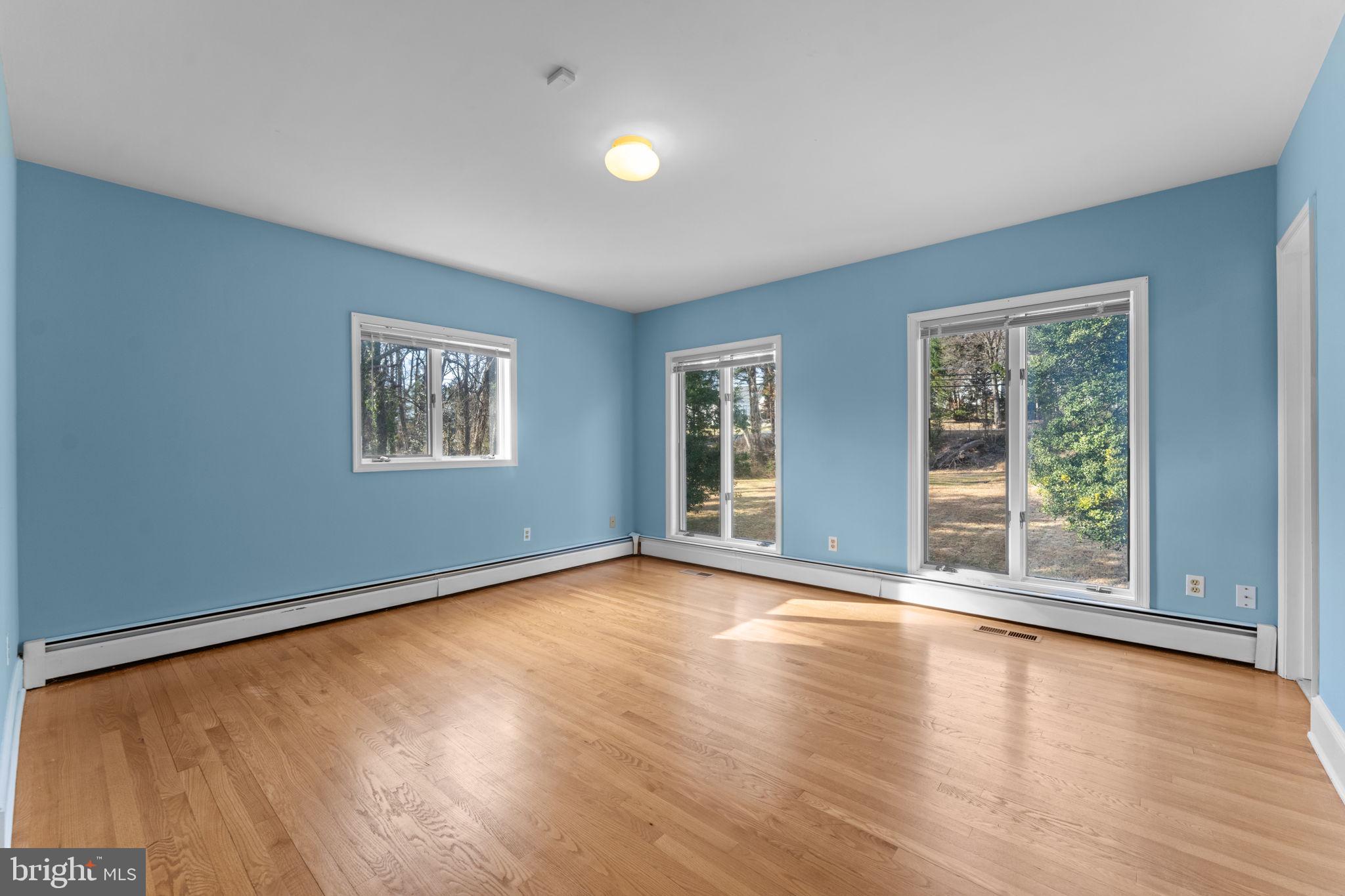 901 Walker Road Great Falls, VA 22066 - Photo 30 of 76 a view of an empty room with wooden floor and a window