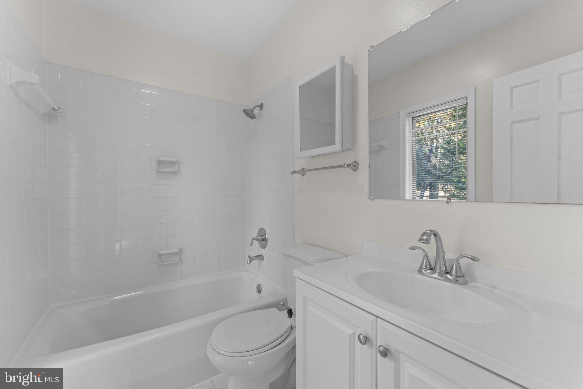 901 Walker Road Great Falls, VA 22066 - Photo 32 of 76 a bathroom with a sink toilet a vanity and shower