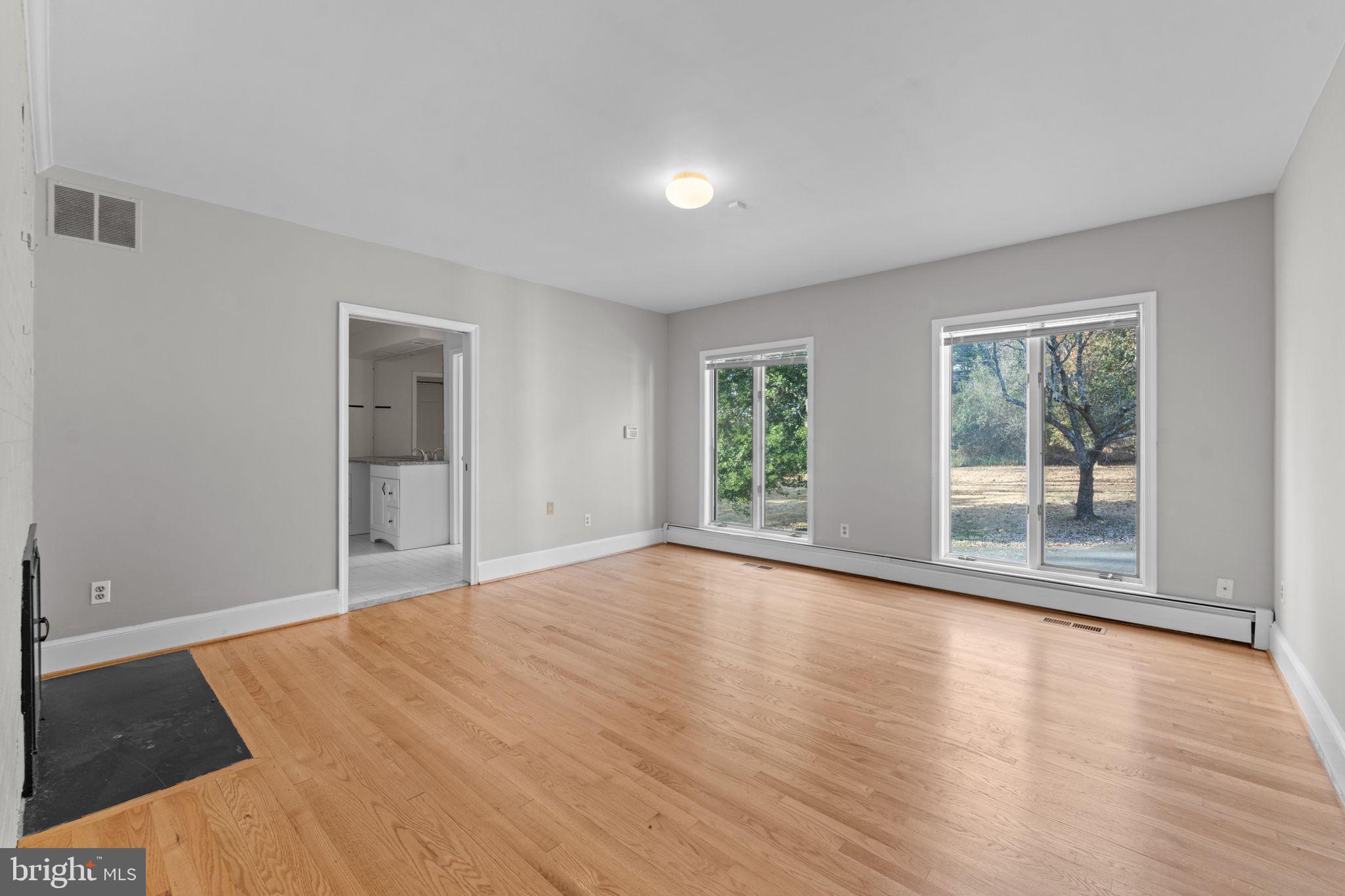 901 Walker Road Great Falls, VA 22066 - Photo 39 of 76 a view of empty room with wooden floor and fan