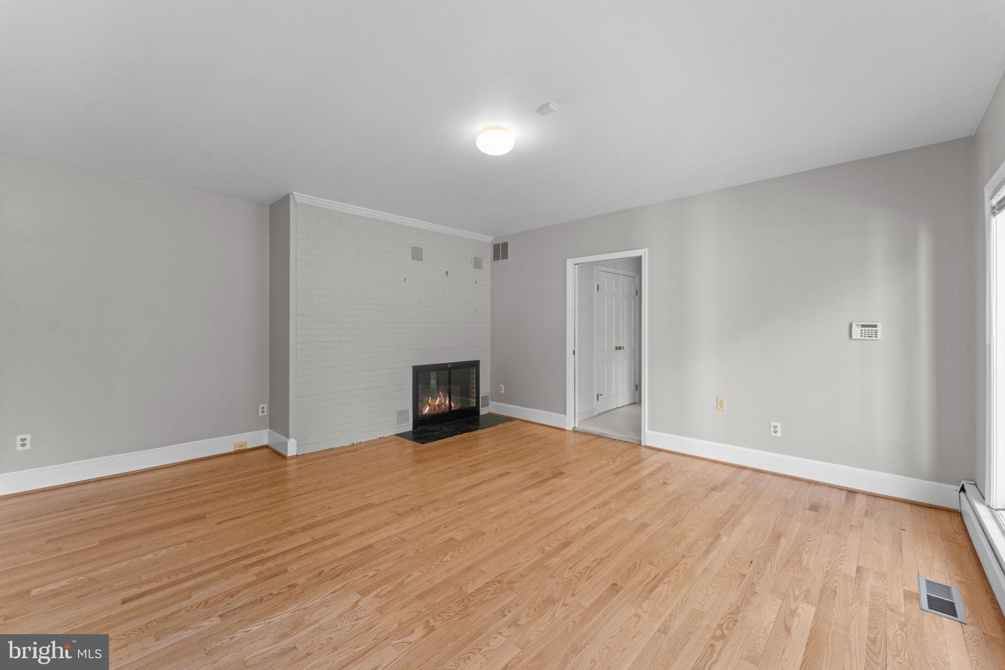901 Walker Road Great Falls, VA 22066 - Photo 40 of 76 a view of an empty room with wooden floor