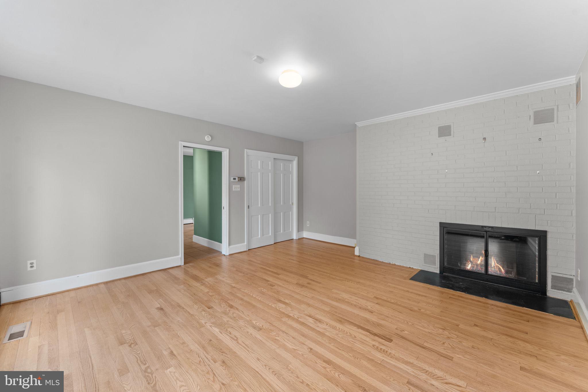901 Walker Road Great Falls, VA 22066 - Photo 41 of 76 a view of empty room with wooden floor and fireplace