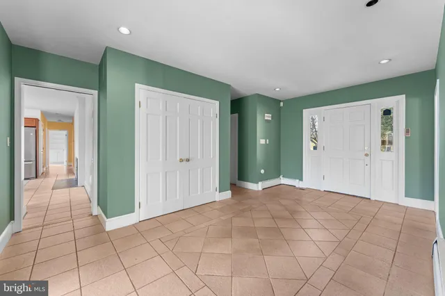 a large kitchen with kitchen island granite countertop a large counter top and stainless steel appliances