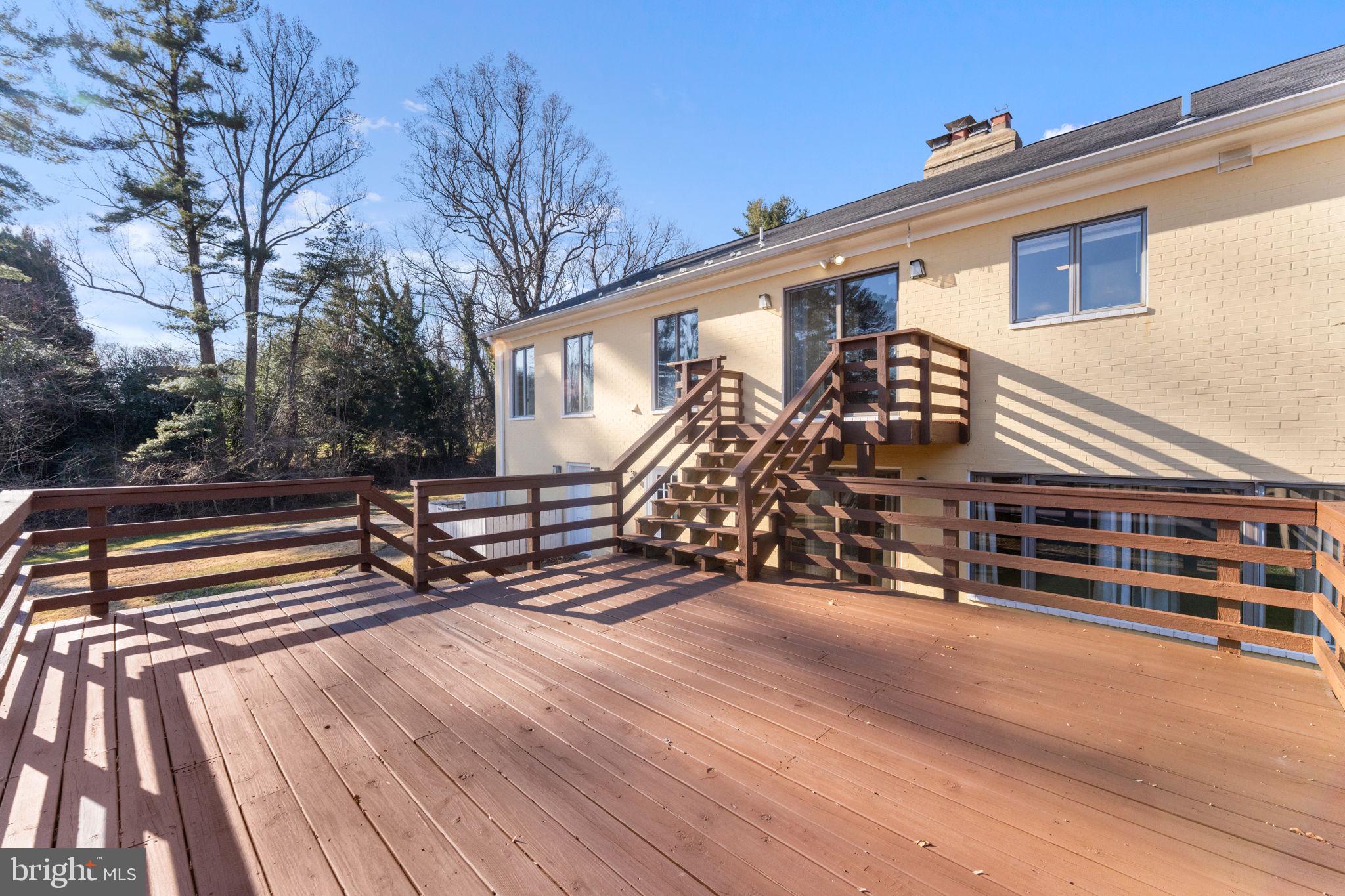901 Walker Road Great Falls, VA 22066 - Photo 57 of 76 a view of a deck with a table and chairs and wooden floor
