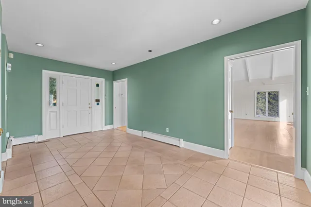 a large kitchen with stainless steel appliances granite countertop a stove and cabinets