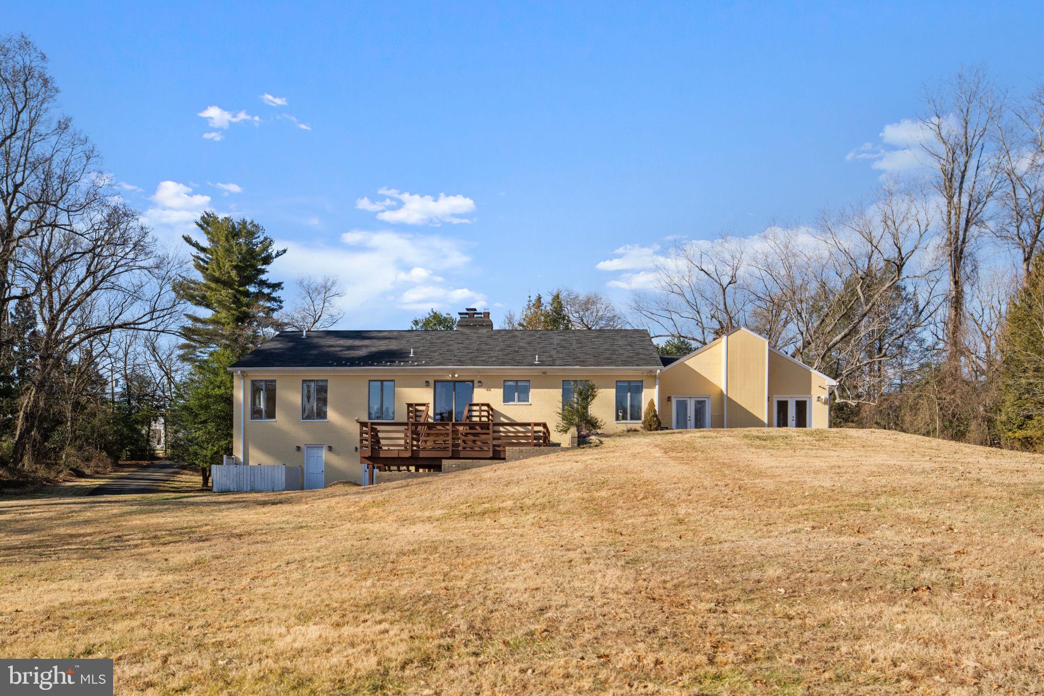 901 Walker Road Great Falls, VA 22066 - Photo 61 of 76 a front view of a house with a yard and trees