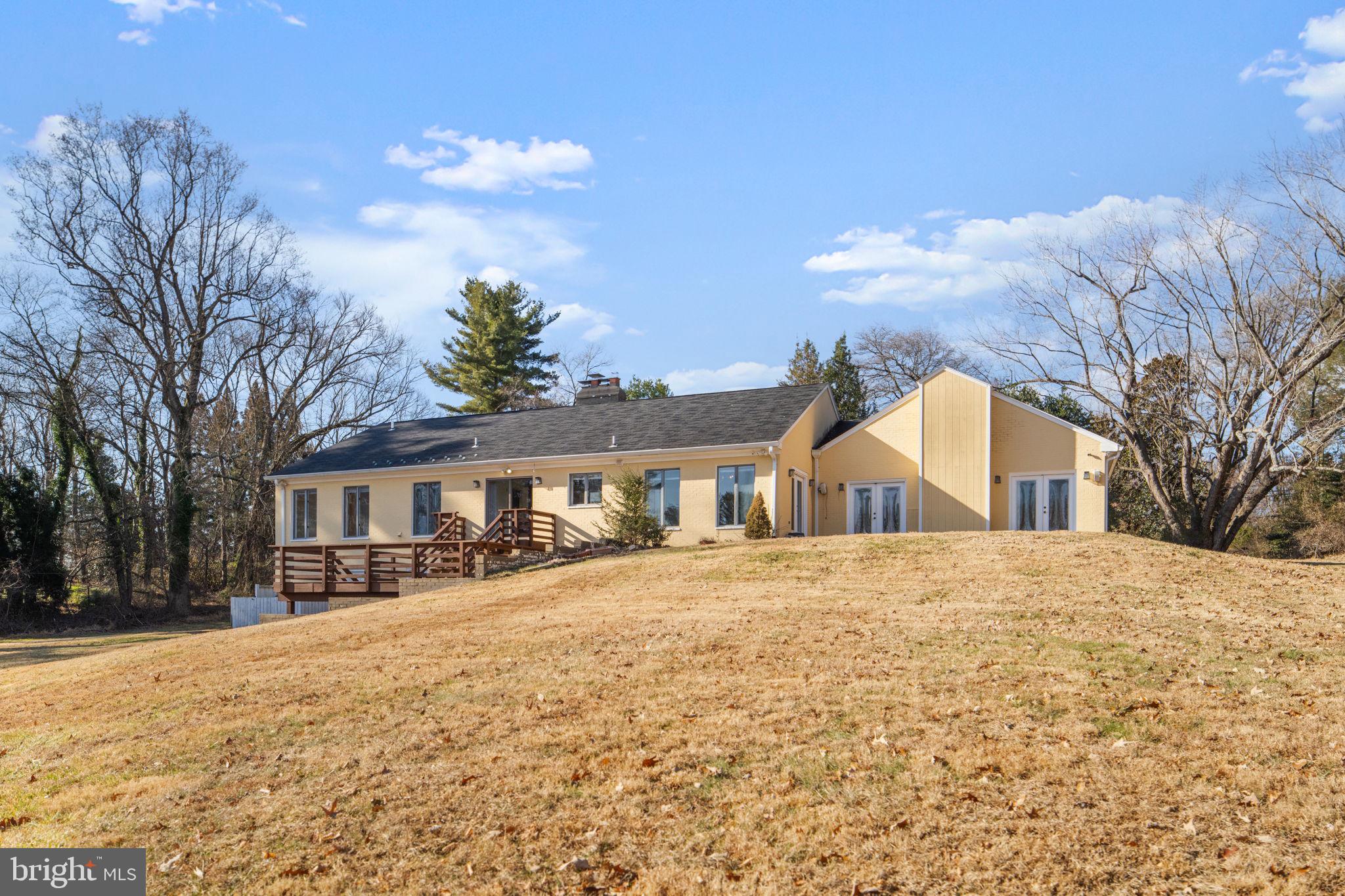 901 Walker Road Great Falls, VA 22066 - Photo 62 of 76 a front view of a house with a yard covered in snow