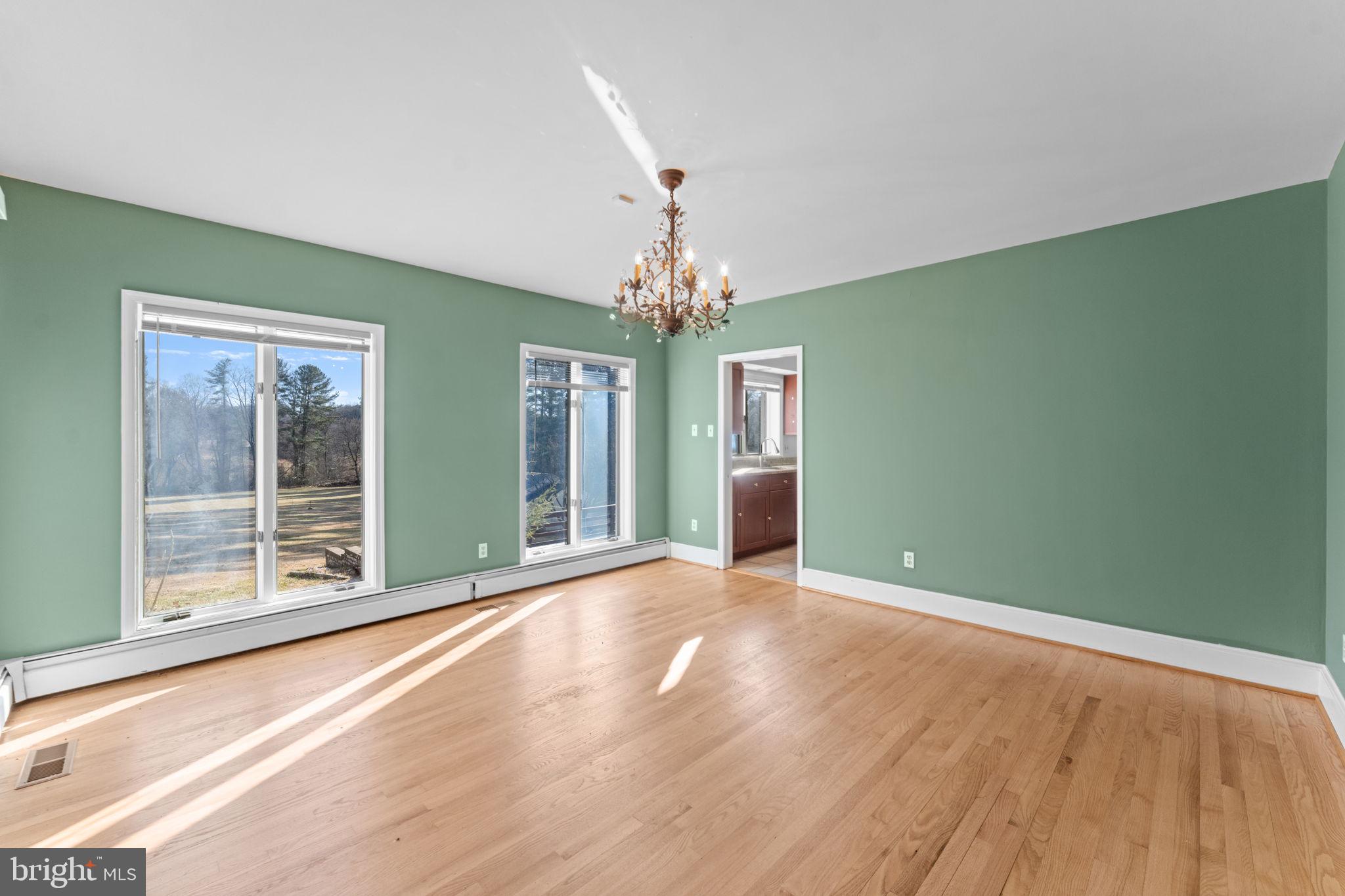901 Walker Road Great Falls, VA 22066 - Photo 9 of 76 a view of an empty room with window and wooden floor