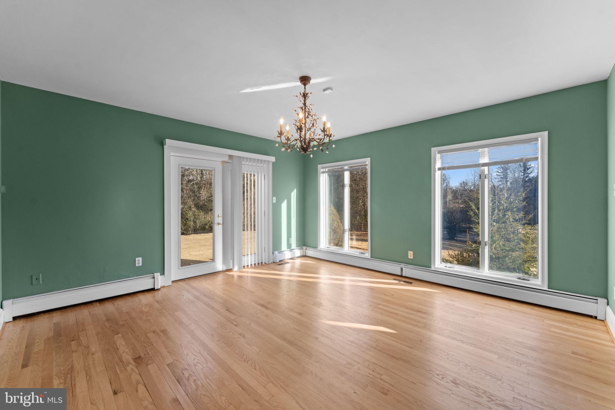 901 Walker Road Great Falls, VA 22066 - Photo 10 of 76 a view of an empty room with window and wooden floor