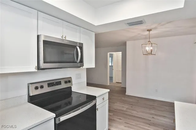 a kitchen with a stove and a microwave