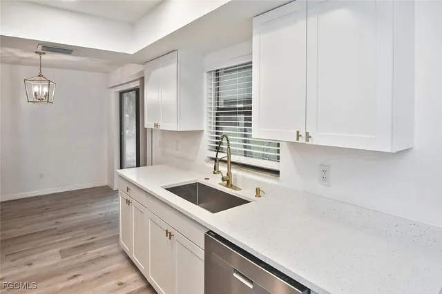 a kitchen that has a sink and a stove